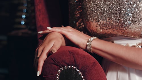 Woman's Hands on a Red Chair in Close Up