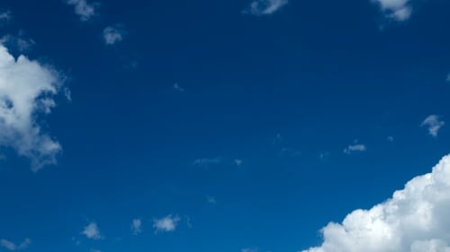 Fluffy Clouds Drifting Across a Brilliant Blue Sky