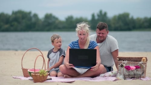 Happy Family Video Calling on Beach Picnic