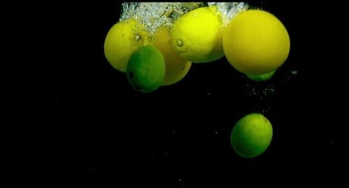 Citrus Fruit In Water On a Black Background