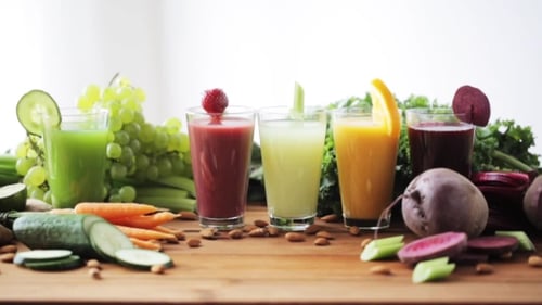 Colorful Vegetable and Fruit Smoothies on Wood Table