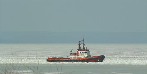 Tugboat Sailing Through Cold Icy Waters