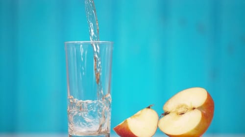 Pouring Fresh Apple Juice into a Glass