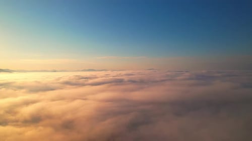 Aerial View of Golden Clouds at Sunrise