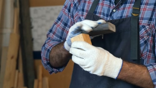 Carpenter Working With Wooden Bar In Workshop.
