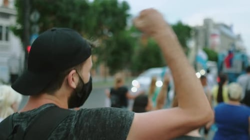 People Demonstrate in City Raising Fists