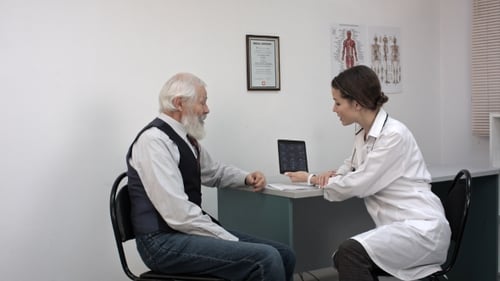 Doctor Consults with Senior Man About Medical Scan