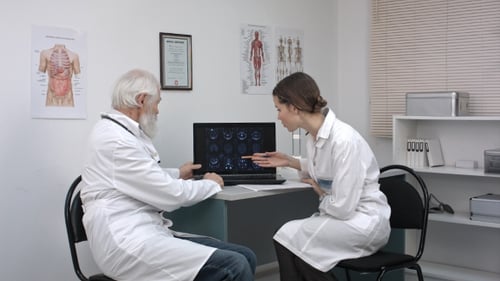 Doctors Reviewing Scans on Computer in Office