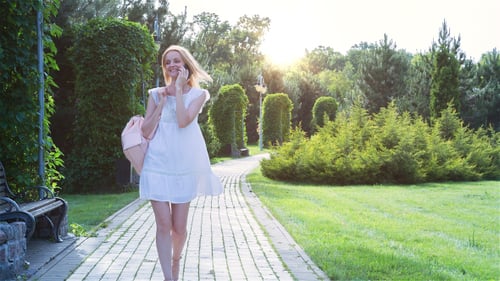 Beautiful Girl Walking Alone in the Park at Sunset 3