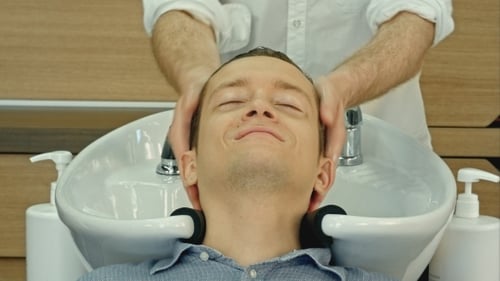 Man Getting Hair Washed at a Salon