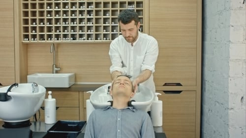 Man Receiving Hair Wash at Modern Salon
