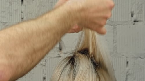 Barber Cuts Blonde Hair in Salon Close Up