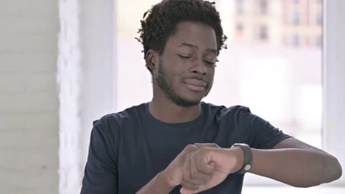 African Man Using Smartwatch in Office