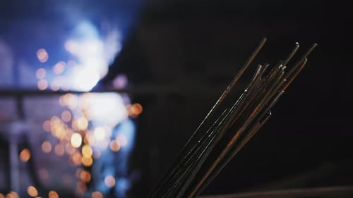 Welding Rods Close Up While Welder Works