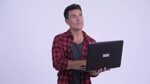 Young Adult Using Laptop and Smiling