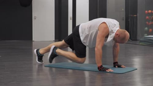 Man Doing Mountain Climber Exercise in Gym