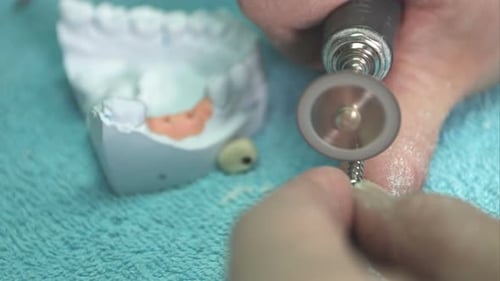 Dental Technician Shaping a Dental Crown