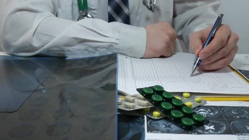 Doctor Reviews X-Ray and Notes on Chart
