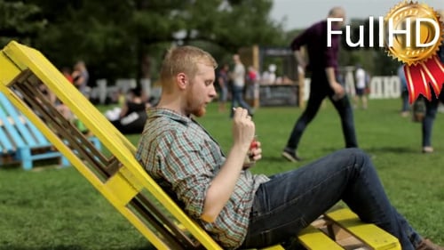 Man Relaxing Eating Fruit in an Urban Park