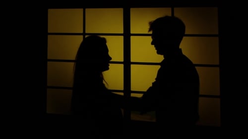 Silhouetted Man Disciplining a Woman in Shadowy Lighting