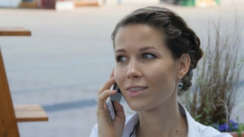 Woman Talking on Cell Phone Outside