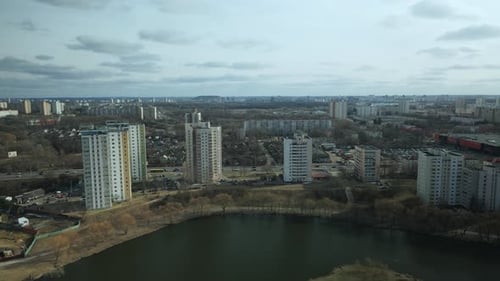 City block near the river. Multi-story houses. Water city system. Aerial photography.