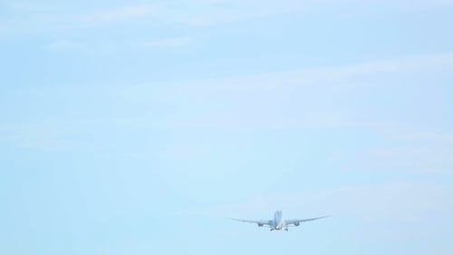 Airplane Takes Off into Light Blue Sky