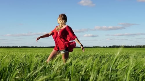 Happy Woman Enjoying Nature Beautiful Blonde Dancing On Field. Freedom Concept.
