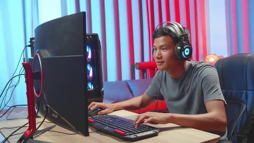 Young Adult Gamer Playing Computer Game