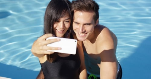 Handsome Couple Take Photo While Standing In Pool