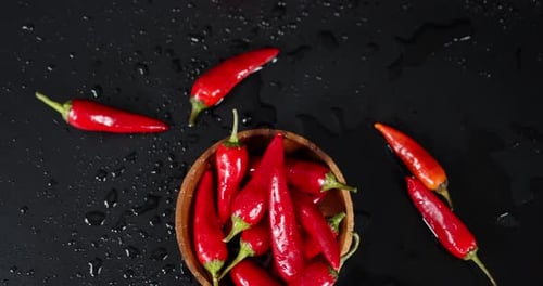 Plate with Red Pepper Falls on the Table.