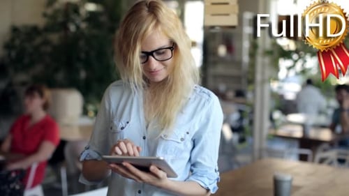 Young Woman Using Digital Tablet at Cafe