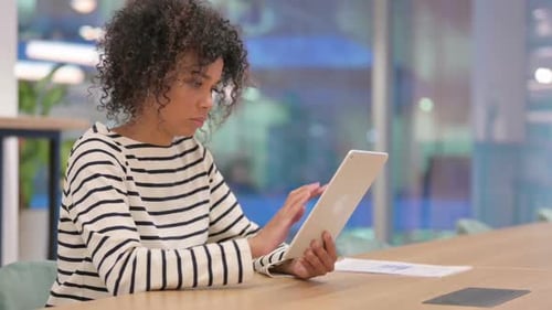Young African Woman Using Tablet in Office