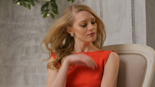 Attractive Woman Posing in Red Dress Indoors