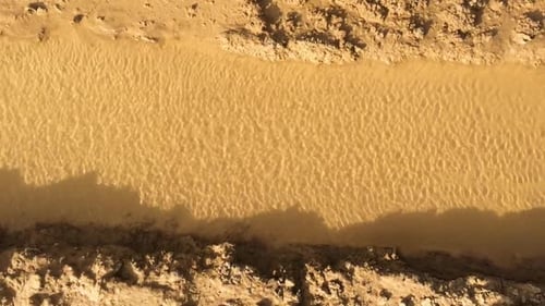 The wind creates small rippling waves on the river