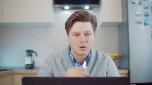 Man Using Nasal Spray While Working at Home