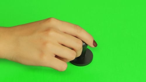 Hand Pressing Stamper Tool on Green Screen