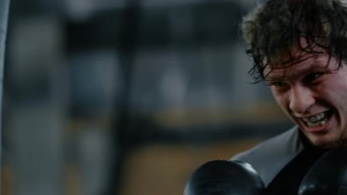 Progressive Fighter Training Hits in Fitness Center. Kickboxer Exercising at Gym