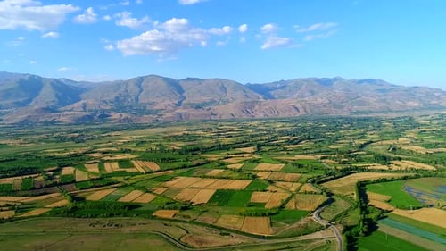 Aerial View of Farmland with Mountains in Background