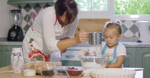 Woman and Child Baking Together in Bright Kitchen