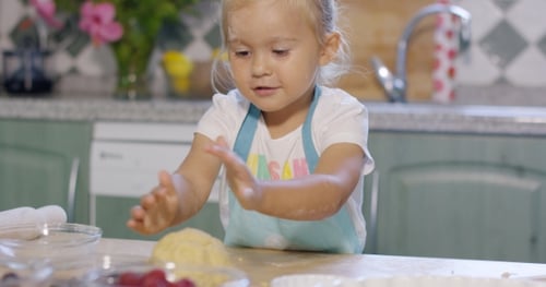 Little Girl Having Fun Kneading The Pastry