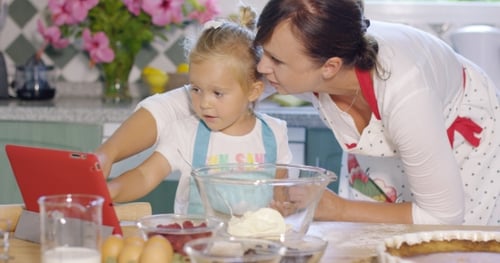 Child and Woman Baking Together in Bright Kitchen
