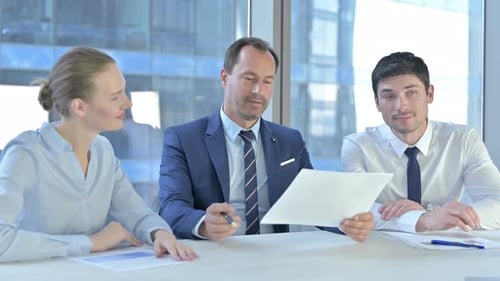 Colleagues Collaborate on Business Strategy in Modern Office