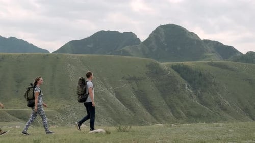 Hikers with Backpacks Walking Mountain Ridge