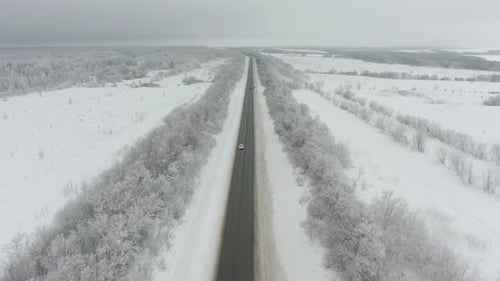 Cars on Road in Winter. Aerial View