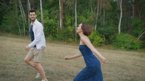 Couple Young People, Male And Female, Fooling Around At Night In The Forest