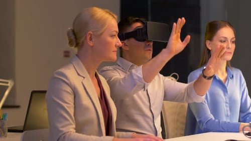Team with Virtual Reality Headset at Night Office