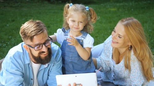 Summer Holidays, Family, Child And Technology Concept - Smiling Family At Park With Tablet Pc