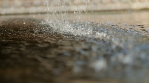 Water Pouring Into Stone Pool in Macro Shot