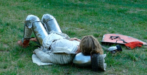 Knight Lying on Grass Field in Armor